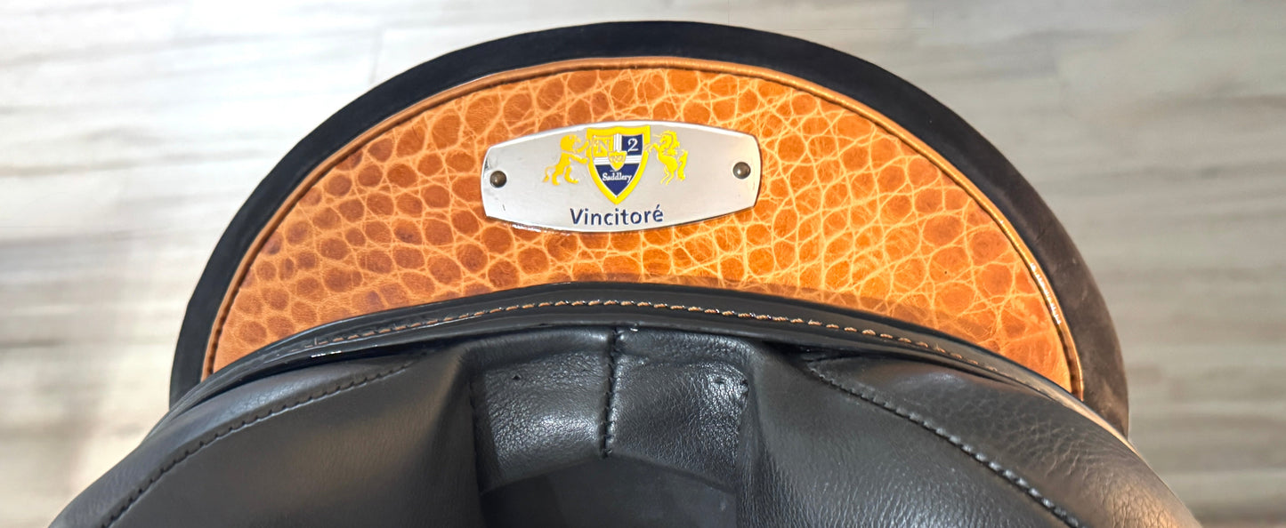 Close-up of a black leather saddle with brown leather flap.